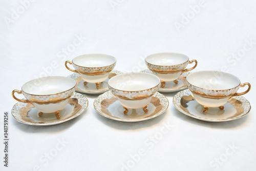 Mock up / design set of elegant and traditional teapot colorful white blue gold coffee cup & Tea cup on cup's plate beside the hot tea pot , design/ drink-ware isolated on white background