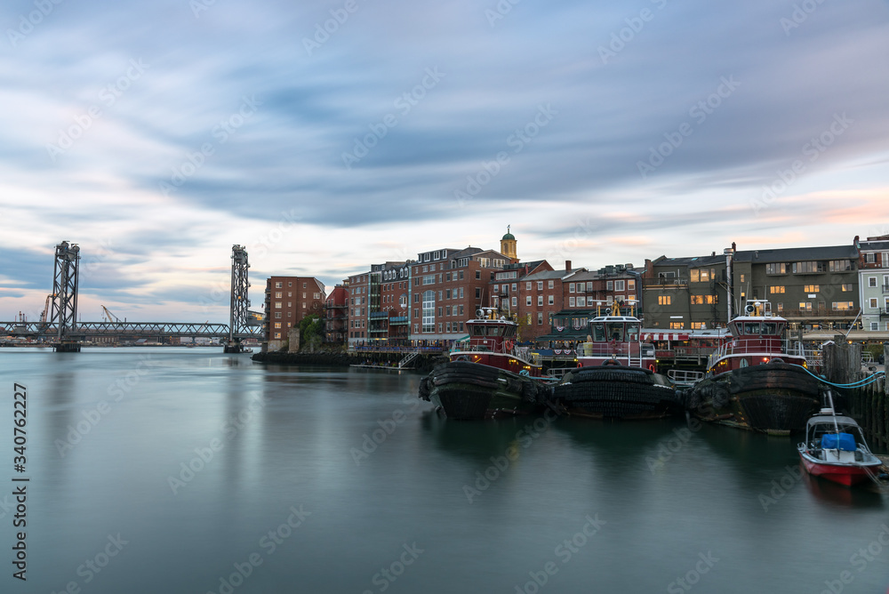 View of Portsmouth skyline and Memorial bridge at sunset. Long exposure. New Hampshire, USA.
