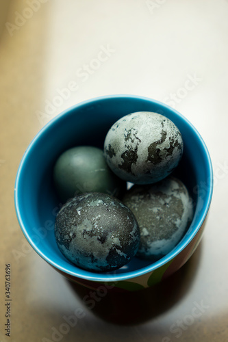 Colorful blue plate bowl with marble pastel coloured Easter eggs