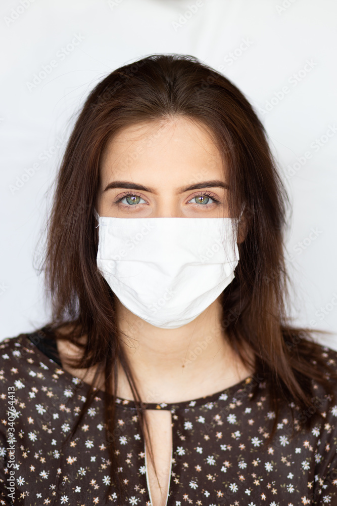 portrait of beautiful young woman wearing cotton white mask and medical/surgical gloves on white background. portrait of beautiful young woman wearing cotton white mask and medical/surgical gloves on white background.
