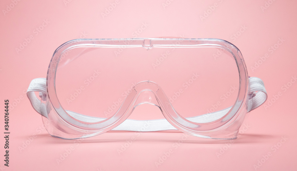 Clear glasses isolated for protection COVID-19 coronavirus on pink background, Health care and surgical concept.. Clear glasses isolated for protection COVID-19 coronavirus on pink background, Health care and surgical concept..