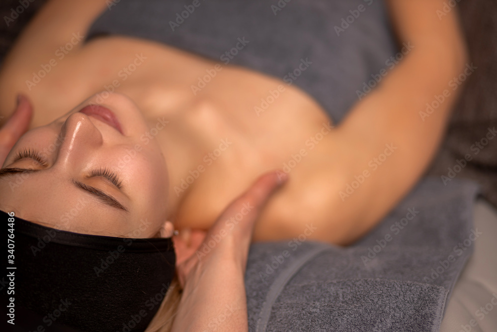 top view on young caucasian woman getting massage on shoulders in spa wellbeing salon. beauty procedures, skin care