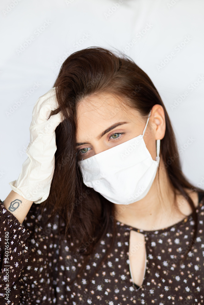 portrait of beautiful young woman wearing cotton white mask and medical/surgical gloves on white background. portrait of beautiful young woman wearing cotton white mask and medical/surgical gloves on white background.