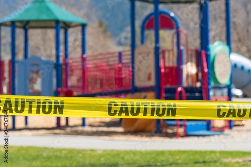 Close-up of cordon tape blocking off a children s playground during coronavirus pandemic