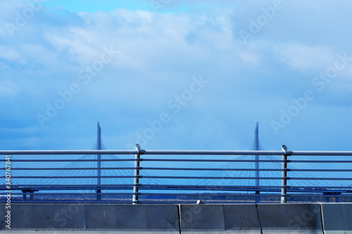 Modern bridges of Saint Petersburg. View from the Betancourt Bridge to the Cable stayed Bridge over the Ship Fairway. View of the Gulf of Finland, blue sky