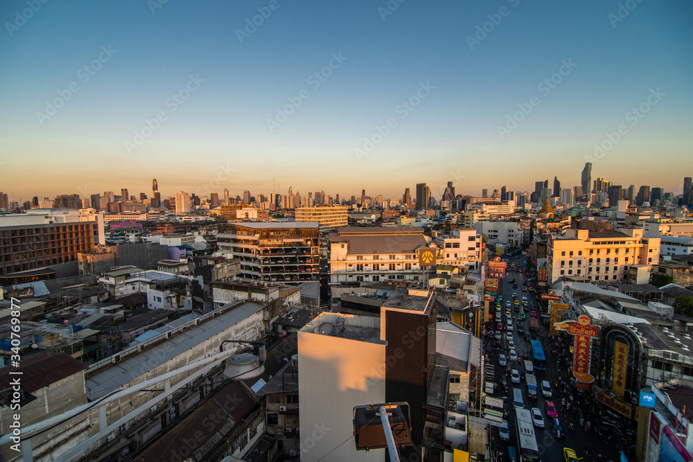 Fototapeta premium Bangkok, Thailand - February 2020: Above view from rooftop on China town in the middle of city Bangkok, Thailand