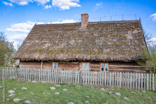 Traditional old polish countryside wooden thatched houses and farmyards.. Dziekanowice, Poland.
