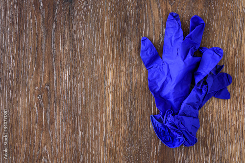 Dark blue nitrile exam gloves on a rustic wood table
 photo