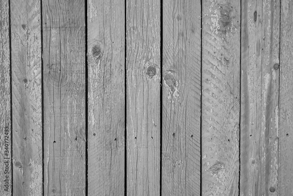 Naklejka premium An old wall of wooden boards as a background in black and white. Copy space.