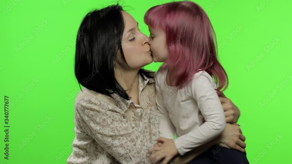 Mother and daughter enjoying playing, hug, embrace, kiss. Mothers day. Family Mother and daughter enjoying playing, hug, embrace, kiss. Mothers day. Family