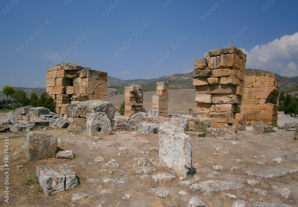 Pamukkale/Turkey. 09.01.2014. Ruins of ancient city in middle east. Historical artifact represents old culture of empire. Popular tourist destination. Blocks made of stone are left.