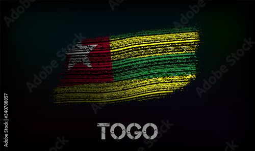 Flag of the Togo. Vector illustration in grunge style with cracks and abrasions. Good image for print