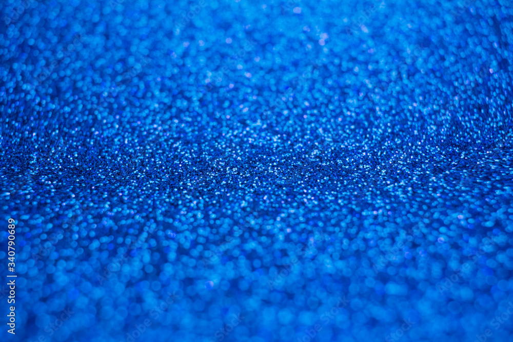 Obraz premium Sparkling bright blue glitter texture background with defocused bokeh