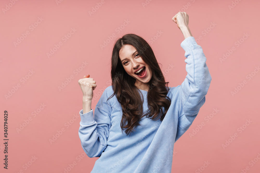 © Drobot Dean - Image of attractive young woman smiling and gesturing in success