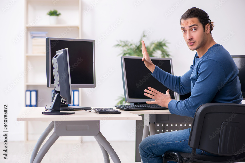 Young male it specialist working in the office Young male it specialist working in the office