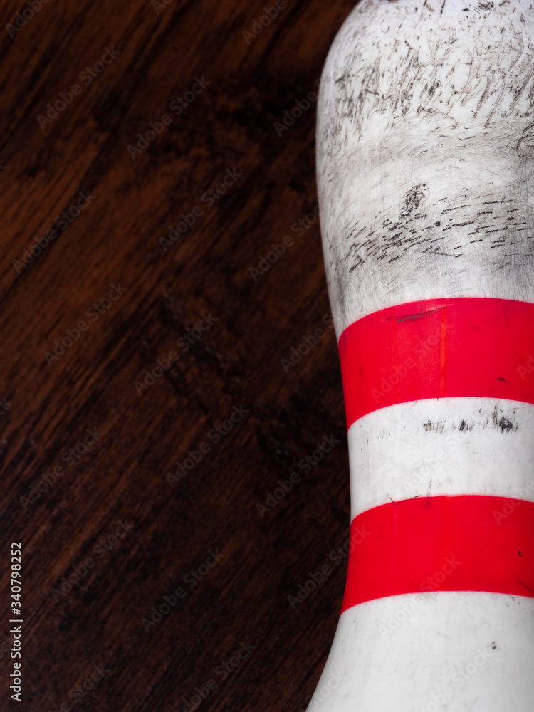 Bowling Pin Laying Vertically on Dark Wood Background Stock Photo