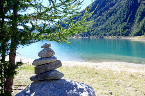 stone pyramids, little man, mound, ovoo, Inukshuk made near the lake or the mountain river photo