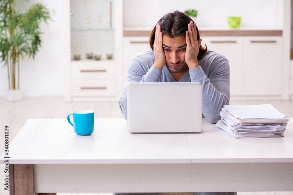 Young male employee freelancer working from home Young male employee freelancer working from home