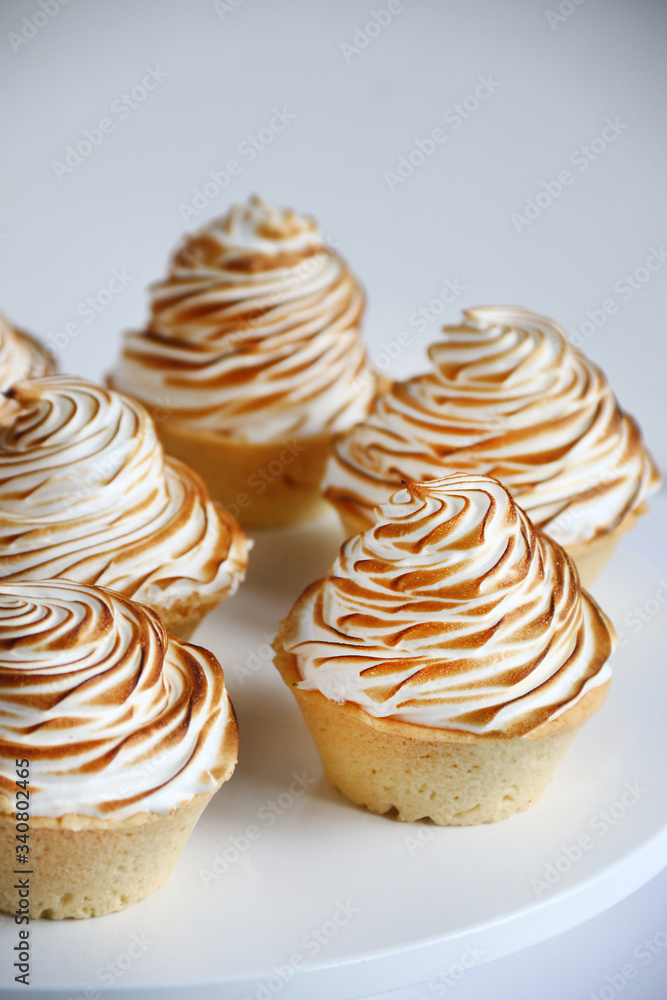 lemon meringue tart closeup on white background. lemon curd tart. tasty lemon mini meringue pie lemon meringue tart closeup on white background. lemon curd tart. tasty lemon mini meringue pie