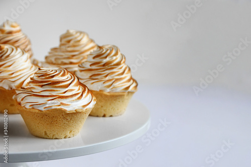 lemon meringue tart closeup on white background. lemon curd tart. tasty lemon mini meringue pie