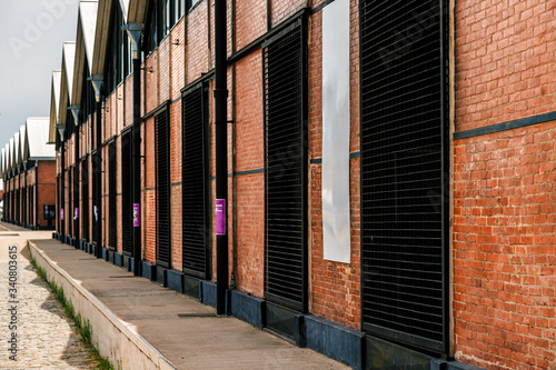 Old restored exposed brick warehouses with black barred windows