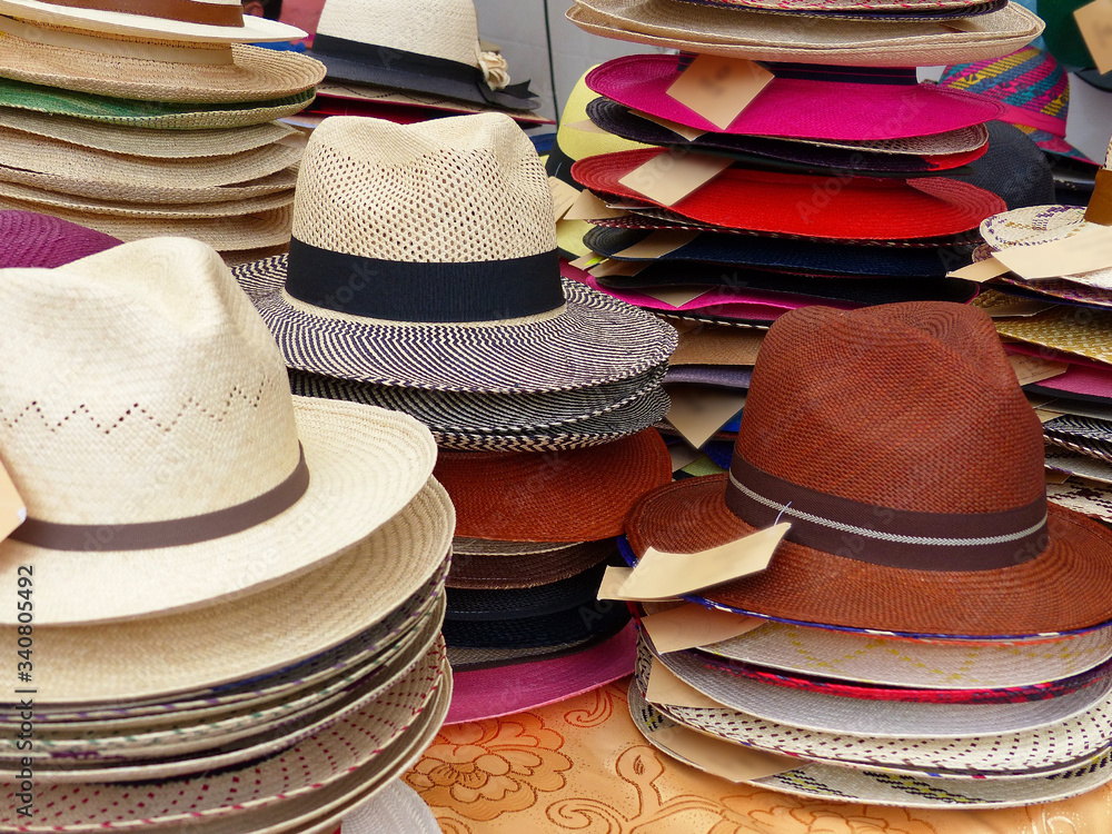 Colorful Handmade Panama Hats or Paja Toquilla hat or sombrero at the traditional outdoor market in Cuenca, Ecuador. Popular souvenir from South America