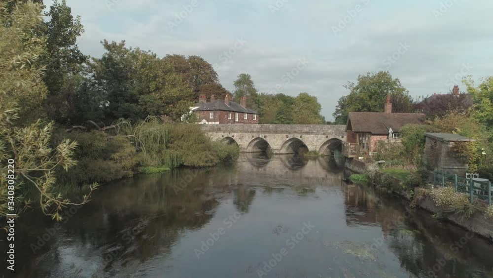 Low aerial pass above the river Avon towards old stone bridge Low aerial pass above the river Avon towards old stone bridge