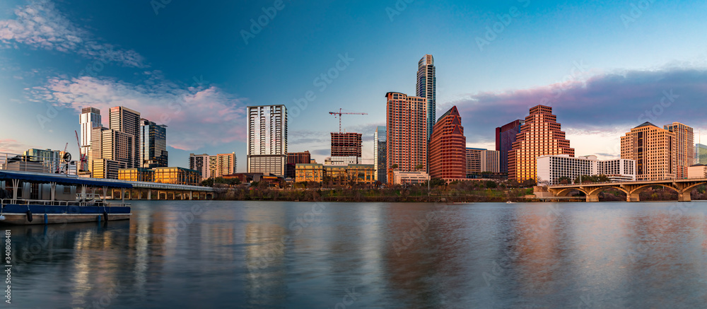Panorama with downtown view across Lady Bird Lake or Town Lake on Colorado River at sunset golden hour, Austin Texas USA
