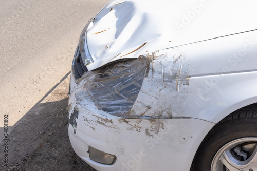 Obraz na płótnie White car accident vehicle destroyed. Headlight sealed with tape and a plastic bag w salonie