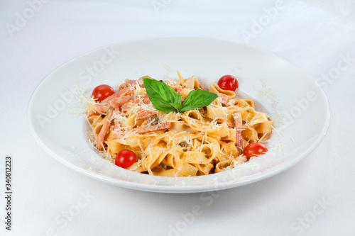 pasta with cheese and tomatoes on a white background