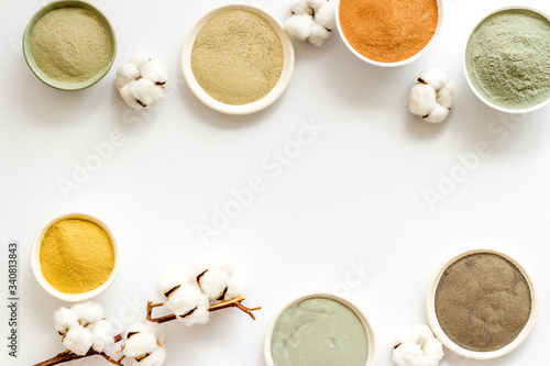 cosmetic clay - Yellow, red, white, blue and black - on white background top-down space for text