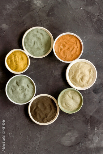 cosmetic clay - Yellow, red, white, blue and black dry powder - top-down flat lay