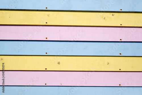 Pink blue and yellow pastel coloured wooden slats