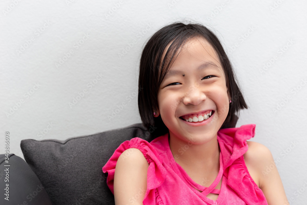 little girl smiling on safa with white background little girl smiling on safa with white background