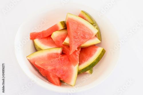 Mediterranean marinated watermelon on isolated white background, special food delivery restaurant menu, take out order, white bowl plate, sliced
