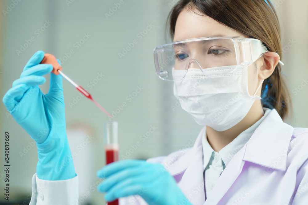 Pipette adding fluid to test tubes. laboratory assistant analysing a blood sample. Pipette adding fluid to test tubes. laboratory assistant analysing a blood sample.