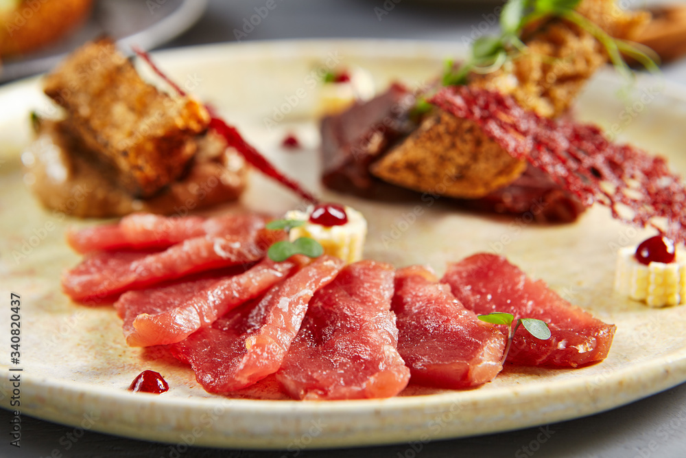 Meat appetizer in beige ceramic plate Meat appetizer in beige ceramic plate