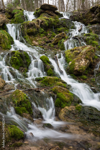 City Cesis  Latvia. Old waterfall with green moss and dolomite rocks.