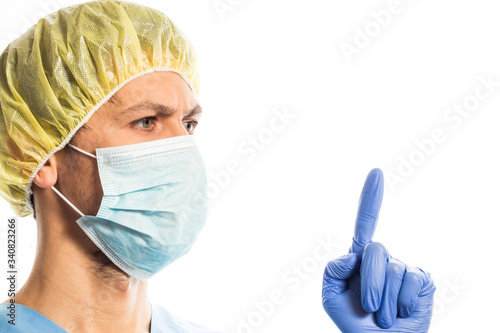 doctor in medical clothes with rubber gloves and a mask  portrait on a white background