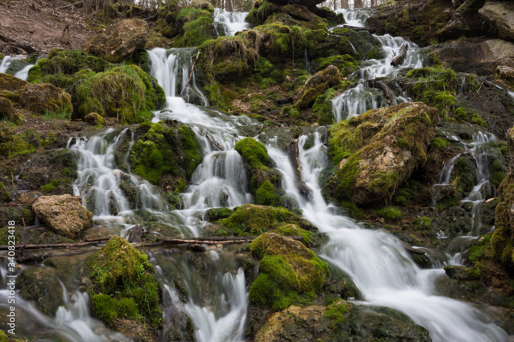 City Cesis, Latvia. Old waterfall with green moss and dolomite rocks.