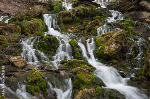 Fototapeta Naklejka Na Ścianę i Meble -  City Cesis, Latvia. Old waterfall with green moss and dolomite rocks.