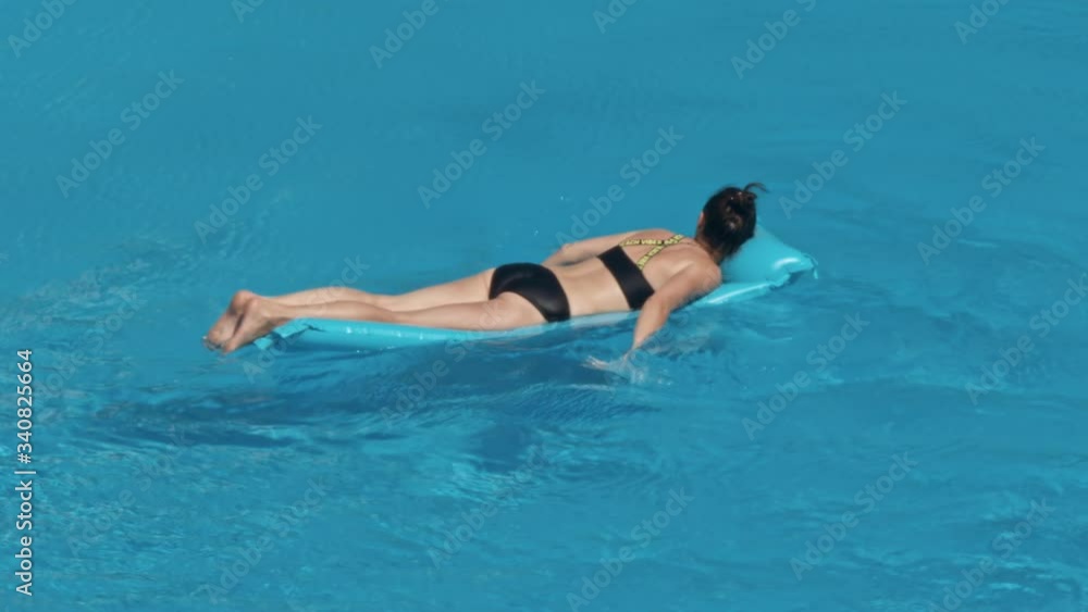 Woman swimming on a blue water pool Woman swimming on a blue water pool