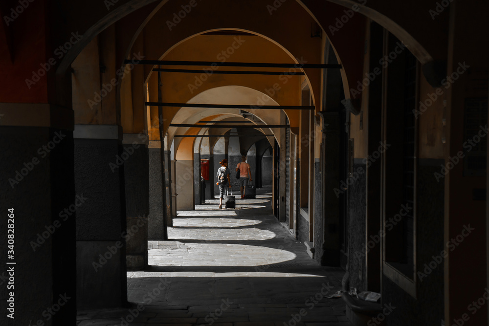 A dark corridor inside the house made of stone arches that let in sunlight | VENICE, ITALY - 16 SEPTEMBER 2018. 