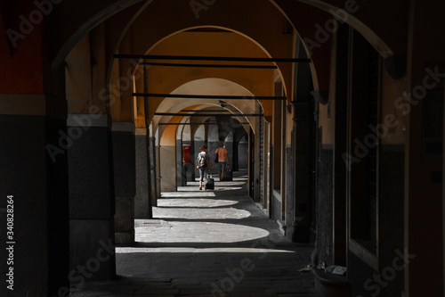 A dark corridor inside the house made of stone arches that let in sunlight | VENICE, ITALY - 16 SEPTEMBER 2018. 