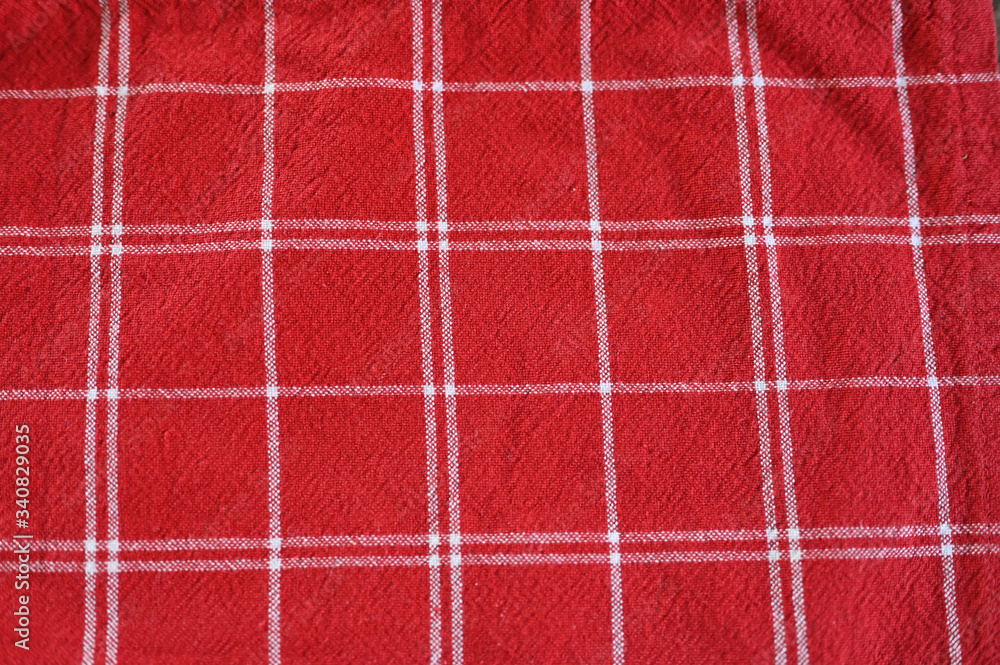 Fototapeta premium red fabric in a white cell. checkered red fabric texture.