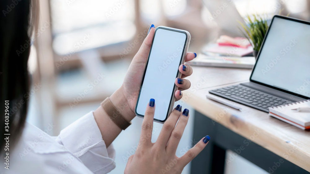 Woman holding blank screen smartphone and touching on screen. Woman holding blank screen smartphone and touching on screen.