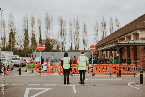 People lining up outside the supermarket with social distancing during coronavirus pandemic. BRISTOL, UK, March 30, 2020
