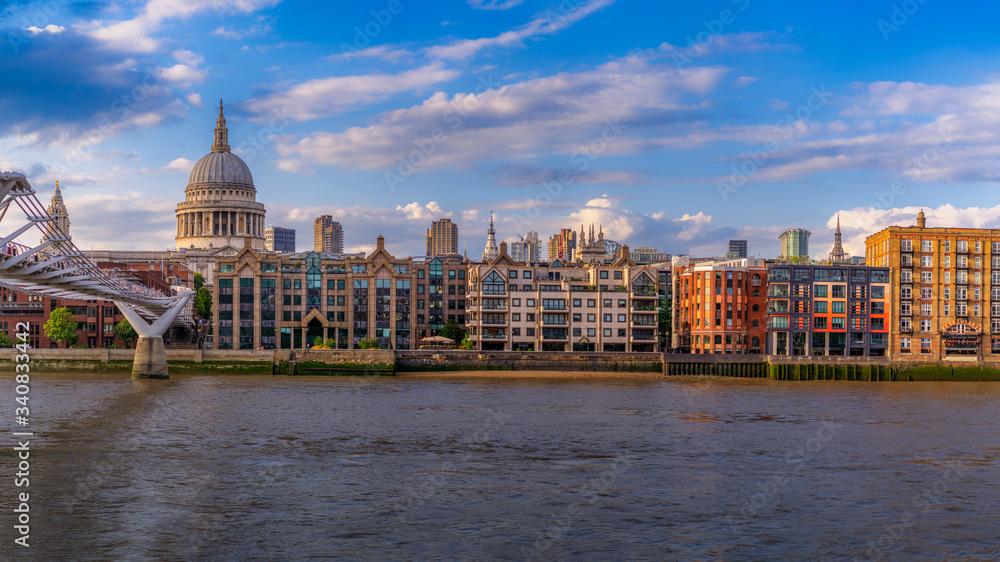 St. Pauls Cathedral across Millennium Bridge and the River Thames in London, UK.