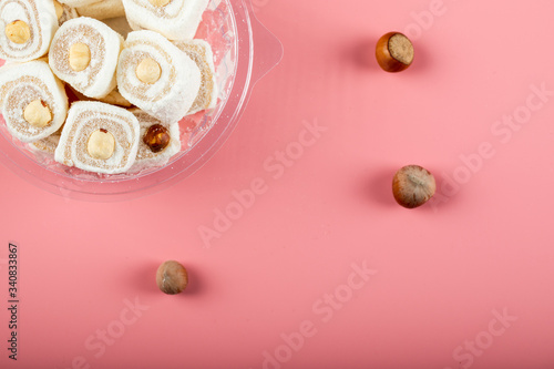 Turkish delight lokum with coconut on pink background