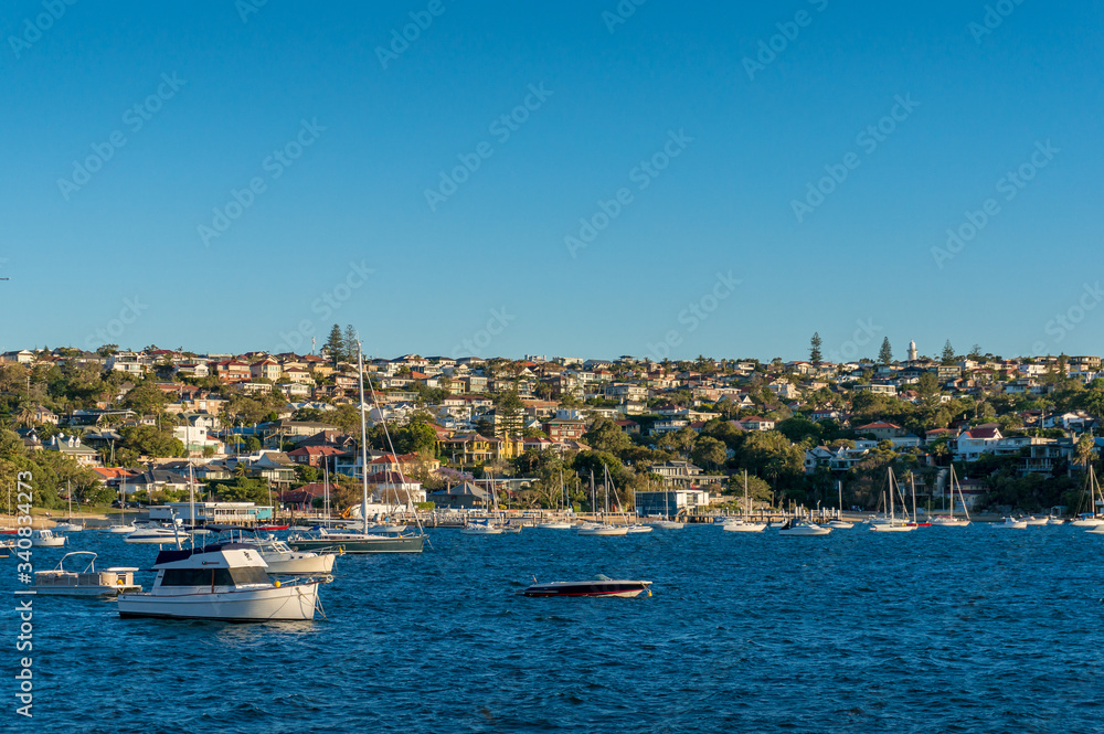 Seaside cityscape with waterfront property and yachts in the bay